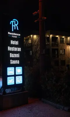 a sign for a hotel in front of a building at Hotel Residence Travnik in Travnik