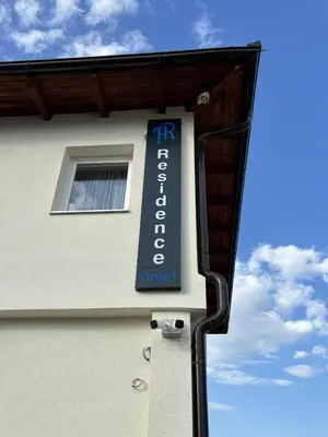 a sign for a hotel on the side of a building at Hotel Residence Travnik in Travnik