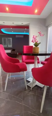 a dining room with red chairs and a table at Apartment Deluxe Livno in Livno