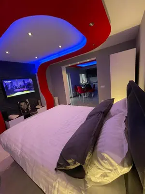 a bedroom with a large bed with a blue ceiling at Apartment Deluxe Livno in Livno
