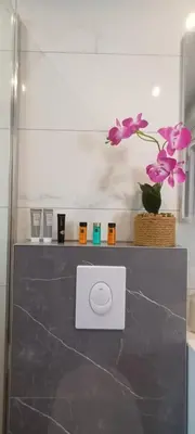 a counter with purple flowers on top of it at Apartment Deluxe Livno in Livno