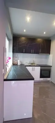 a kitchen with a black counter top in a room at Apartment Deluxe Livno in Livno