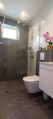 a bathroom with a shower and a toilet and a sink at Apartment Deluxe Livno in Livno
