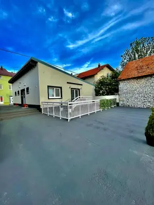 a building with a parking lot in front of it at Apartment Deluxe Livno in Livno