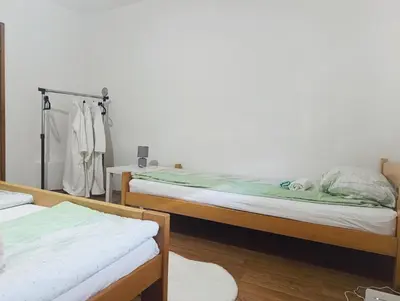 a bedroom with two bunk beds and a closet at Apartman Maric in Drvar