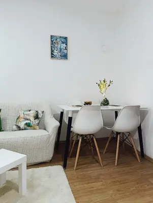 a living room with a table and a couch at Apartman Maric in Drvar