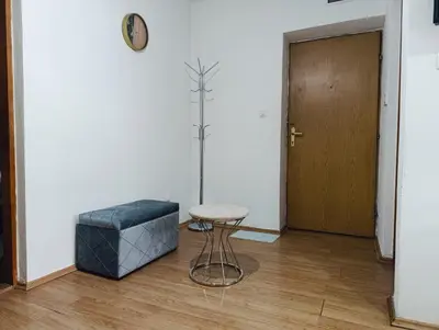 a room with a stool and a table and a door at Apartman Maric in Drvar