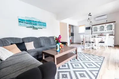 a living room with a couch and a table at Delta apartments in Bihać