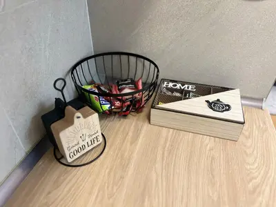 a table with a basket of books and a box at River Apartment in Banja Luka