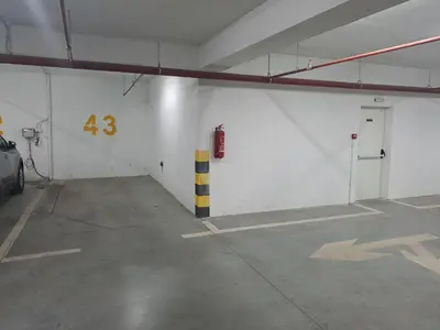 an empty parking garage with the number on the wall at River Apartment in Banja Luka