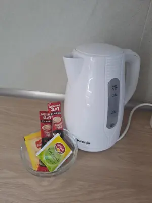 a white blender and a bowl of food next to a cup at River Apartment in Banja Luka