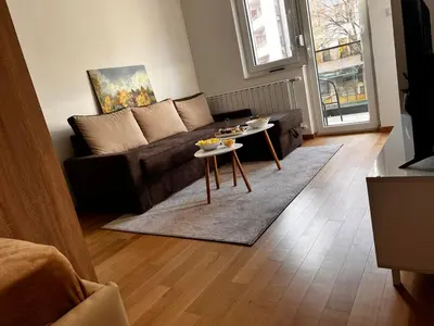 a living room with a couch and a table at River Apartment in Banja Luka