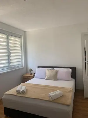 a bedroom with a bed with two towels on it at Apartman CENTAR 1 in Jajce