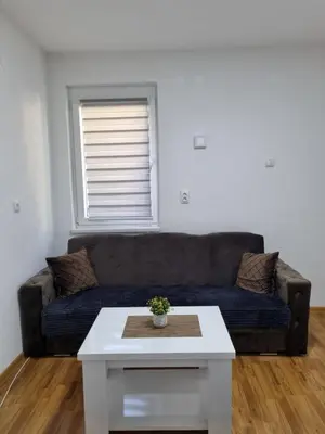 a living room with a couch and a coffee table at Apartman CENTAR 1 in Jajce