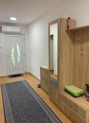 a room with a mirror and a dresser and a door at Apartman CENTAR 1 in Jajce