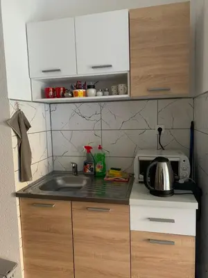 a kitchen with a sink and a microwave at Apartman CENTAR 1 in Jajce
