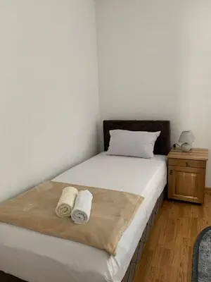 a bedroom with a bed with two towels on it at Apartman CENTAR 1 in Jajce