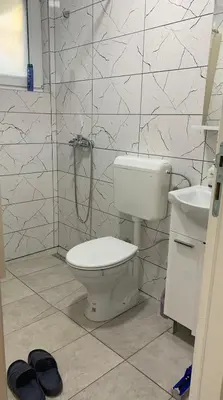 a bathroom with a toilet and a shower and a sink at Apartmani CENTAR in Jajce