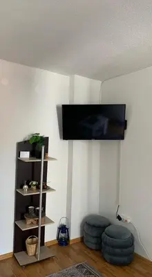 a living room with a flat screen tv on a wall at Apartmani CENTAR in Jajce