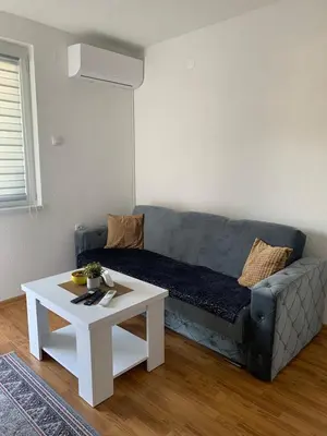 a living room with a couch and a table at Apartmani CENTAR in Jajce