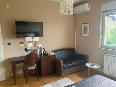 a room with a desk with a chair and a couch at Bolek mansion in Banja Luka