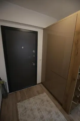 a large black door in a room with a rug at Apartman Hana Fojnica in Fojnica