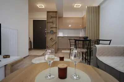 two wine glasses sitting on a table in a living room at Apartman Hana Fojnica in Fojnica