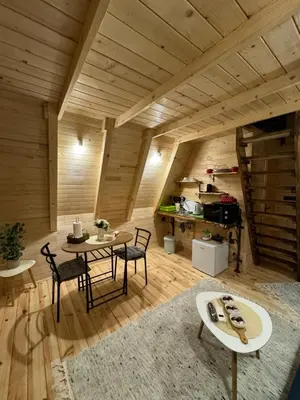 a room with a table and chairs and a kitchen at Dream House Una in Orašac