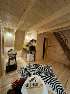 a zebra print bed in a room with a wooden floor at Dream House Una in Orašac
