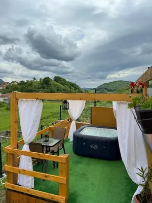 a view from the deck of a farmhouse with a hot tub and a patio at Dream House Una in Orašac