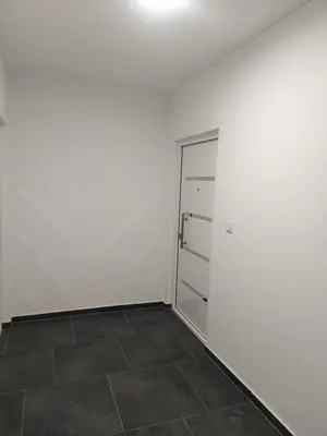 an empty room with a door and a tile floor at Pinocchio in Bihać