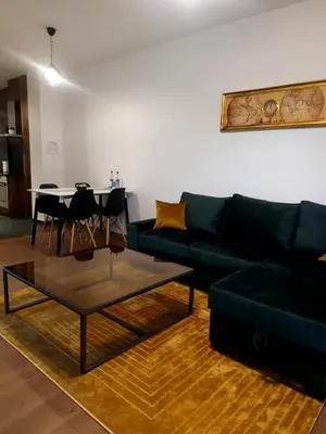 a living room with a green couch and a table at Pinocchio in Bihać