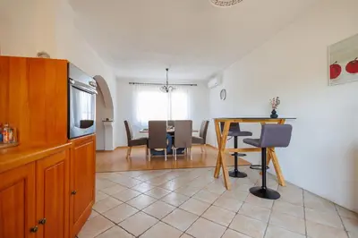 a kitchen and dining room with a table and chairs at Guest House Fiona in Bihać