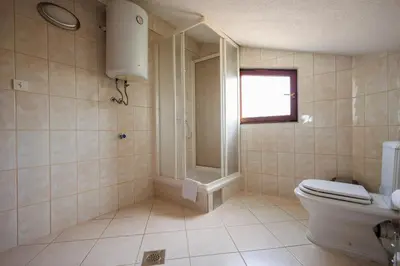 a bathroom with a toilet and a shower at Guest House Fiona in Bihać