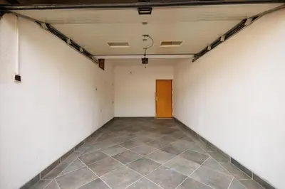an empty room with a tile floor and a door at Guest House Fiona in Bihać