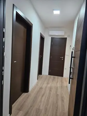 an empty hallway with two doors and wooden floors at Mrakovica 1935 in Prijedor