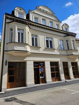 a large white building on a city street at Mrakovica 1935 in Prijedor