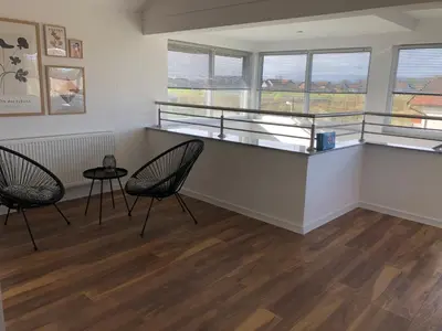 a room with two chairs and a counter with windows at Apartment Vuleta Deluxe Extra groß in Prijedor