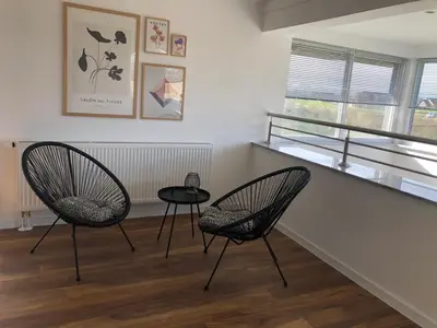 two chairs and a table in a room with a window at Apartment Vuleta Deluxe Extra groß in Prijedor