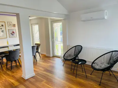 a living room with chairs and a table at Apartment Vuleta Deluxe Extra groß in Prijedor