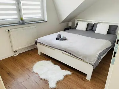 a bedroom with a bed with a white rug at Apartment Vuleta Deluxe Extra groß in Prijedor