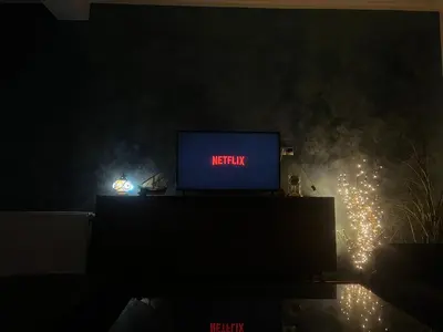 a television sitting on a table in a dark room at Apartman Elma in Bihać