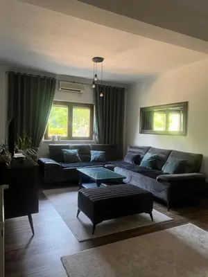 a living room with two couches and a table at Apartman Elma in Bihać