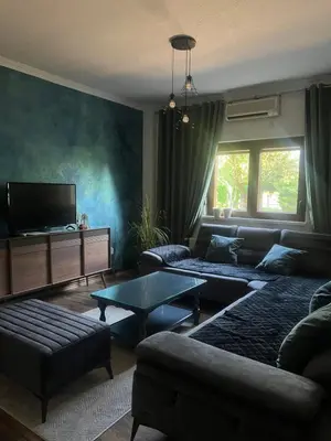 a living room with a couch and a tv at Apartman Elma in Bihać