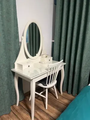a white dressing table with a mirror and a chair at Apartman Elma in Bihać