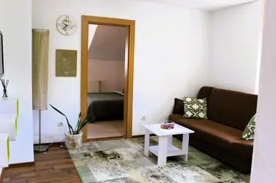 a living room with a couch and a table at Svila Apartmani in Bihać
