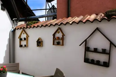 a wall with several small houses on it at Svila Apartmani in Bihać