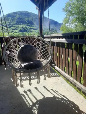 a swinging chair with a view of a mountain at Hasan's apartment - holiday house - vikendica - kuća za odmor - apartman in Visoko