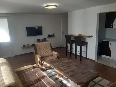 a living room with a couch and a table and chairs at Hasan's apartment - holiday house - vikendica - kuća za odmor - apartman in Visoko