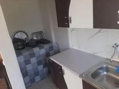 a small kitchen with a sink and a counter at Hasan's apartment - holiday house - vikendica - kuća za odmor - apartman in Visoko